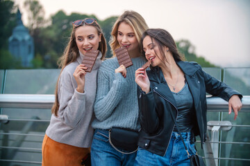 three girls eating chocolate