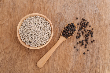 White pepper and   black pepper on old wooden