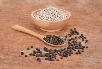 White pepper and   black pepper on old wooden