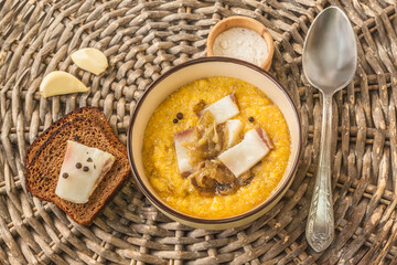 Banosh with toasted bacon and onions. Hutsul lunch. Flat lay