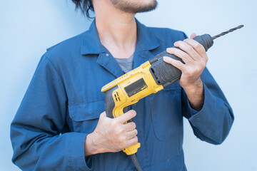 A mechanic with a drill