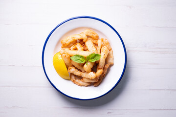 Traditional spanish tapa. Rabas, tasty fried squid with lemon.