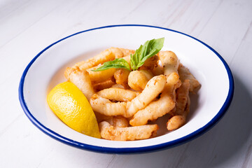 Traditional spanish tapa. Rabas, tasty fried squid with lemon.