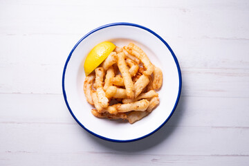 Traditional spanish tapa. Rabas, tasty fried squid with lemon.