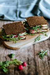 Food still life, fresh whole grain bread with cheese, radish, cucumber, arugula, healthy food, superfood