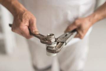 Man take two keys wrench and balloon in hands