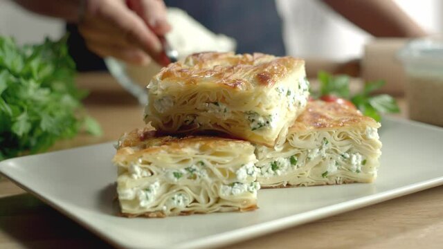 Turkish pastry with feta cheese is served in slow motion.