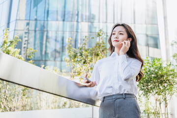 woman talking on cell phone with bluetooth headset