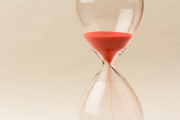 Crystal hourglass on champagne background as a concept of passing time for business term, urgency and outcome of time.