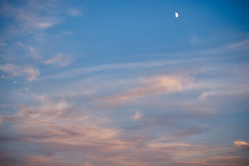 Month on blue sky with clouds