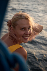 Portrait of a happy smiling woman on the background of a beautiful sea