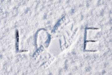 Footprint of boots on inscription Love. Concept of divorce, breakup, broken heart, giving up on love, end of relationship.