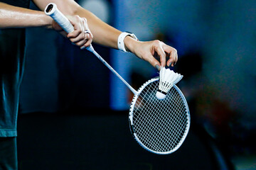 holding a white badminton racket ready to hit the ball - obrazy, fototapety, plakaty