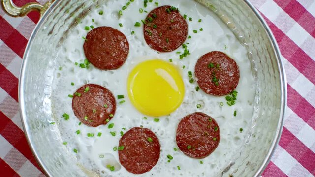 Turkish cuisine egg and sausage. Sausage cooked with butter in a frying pan.
