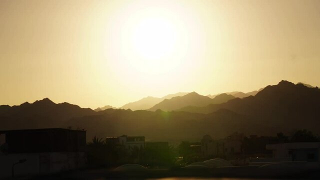 Sunset Timelapse Above Village and Mountain Hills in Desert of Egypt