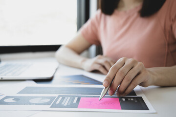 Financial businesswomen analyze the graph of the company's performance to create profits and growth, Market research reports and income statistics, Financial and Accounting concept.