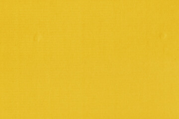 Clean yellow retro paper background. Vintage cardboard texture. Grunge paper for drawing. Simple blank fabric pattern.