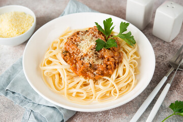 Traditional Italian pasta with bolognese sauce in a white plate