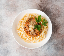 Traditional Italian pasta with bolognese sauce in a white plate