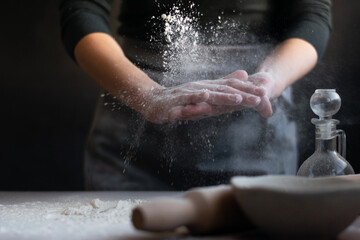 Fototapeta na wymiar Woman baker with flour in her hands