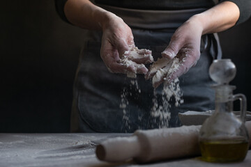 Woman baker with flour in her hands