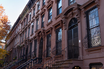 Row of Beautiful Old Brownstone Homes with Stairs in Park Slope Brooklyn New York during Autumn