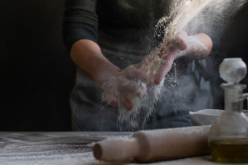 Woman baker with flour in her hands