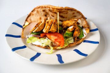 Chicken shawarma in pita bread with vegetable salad.