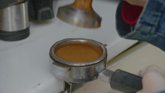Close-up, Slow Motion, Hand of Girls Holds Temper and Tramples Ground Coffee in Holder's Filter for Coffee Machine