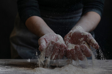 Woman baker with flour in her hands