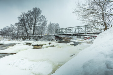 Waterfall in winter, strong current, frozen ice
  and trees in other. landscape photography
  Frost, ice, cold concept. Old town in Helsinki