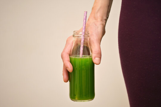 Woman Hand Drinking Healthy Green Drink After Training