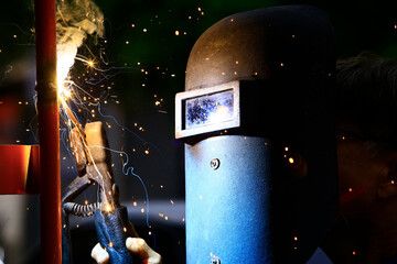The worker is welding the steel at work.