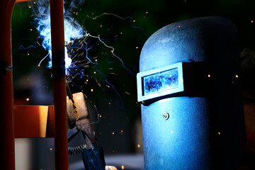 The worker is welding the steel at work.
