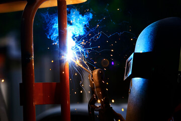 The worker is welding the steel at work.