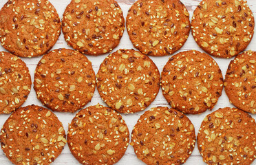 Freshly baked homemade vegan oatmeal cookies with cereals - flax seed, sesame and sunflower. Useful snack. The concept of healthy eating. Culinary background top view