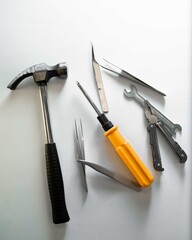 Construction work tools lie on a gray background in a chaotic manner