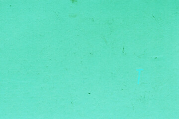Cardboard green abstract pattern texture close-up. Retro old paper background. Grunge concrete wall. Vintage blank wallpaper.