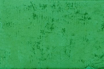 Cardboard green abstract pattern texture close-up. Retro old paper background. Grunge concrete wall. Vintage blank wallpaper.