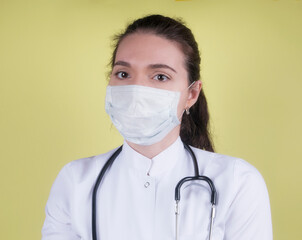 Medical staff preventive gear against coronavirus. Portrait of female doctor with stethoscope in mask. 