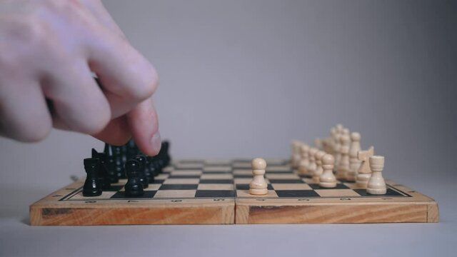 Two people play on a chessboard, a woman and a man move pawns in sequence