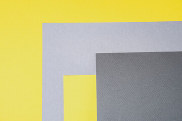 Fototapeta premium Gray and yellow paper top view. Template with geometric shapes for design in trendy colors with place for text