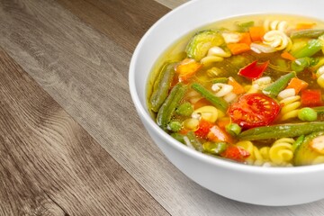 Bowl of delicious vegetable soup on a table