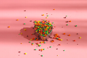 Multicolored candies on a pink background. Food concept.