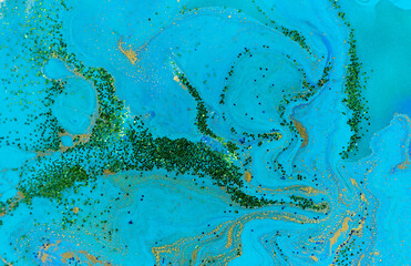 Green, blue and gold marbling pattern. Ink stripes with green and golden glitter.