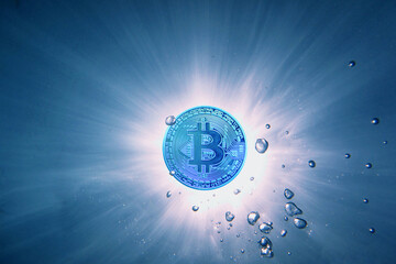 blue bitcoin instead a sun view from underwater with bubbles