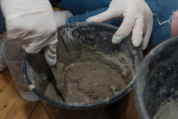 Fototapeta premium Craftsman Mixes Water, Sand And Cement To Concrete - Close-up