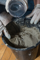 Handyman Mixing With A Spatula Concrete - Closeup