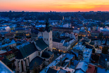 Fototapeta premium Aerial view of Latin cathedral and Rynok square in Lviv, Ukraine at sunset. View from Lviv town hall