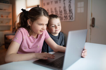 boy and girl looking at a laptop with a worried and confused look